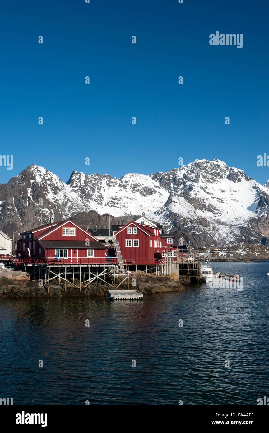 Traditional red wooden Rorbu fishermens` huts in village of Henningsvaer in Lofoten Islands in Norway Stock Photo